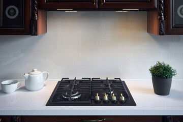 Warm light interior of modern kitchen in classic style with golden elements cherry alder wood...