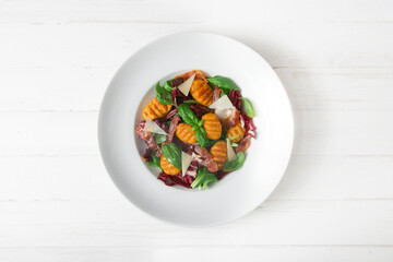 Pumpkin gnocchi salad with parmesan and bacon