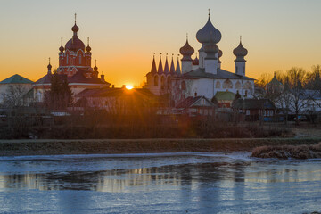 Temples of the Tikhvinsky Theotokos Assumption Monastery against the background of the December sunset. Leningrad region, Russia