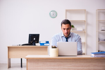 Young male employee unhappy with excessive work