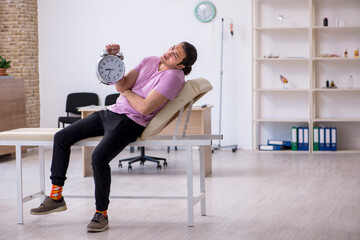 Young male patient waiting for doctor in time management concept