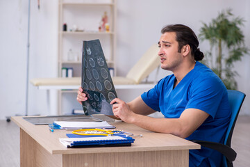 Young male doctor radiologist being unhappy after night shift