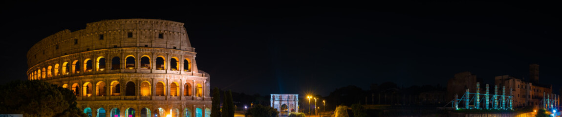 Naklejka premium Night time panorama of Colosseum and Temple of Venus and Rome 