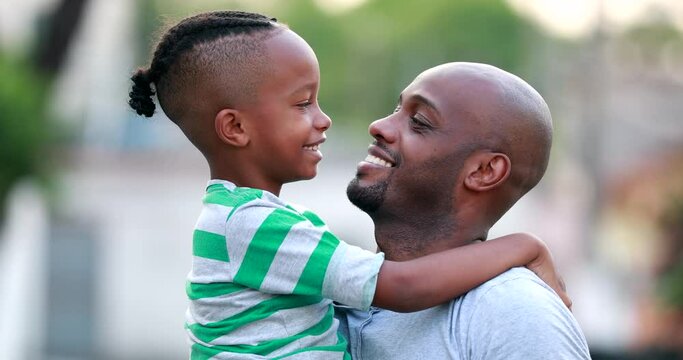 Father and son doing eskimo kiss. African black dad and child bonding together. Family love and affection