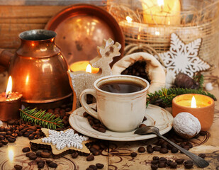 Cup of coffee and jute sack with raw grains on the table.