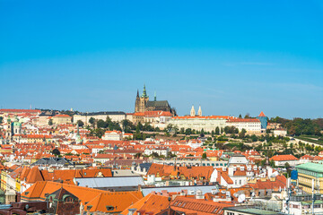 Fototapeta na wymiar Top view of red roofs and Prague's castle in Czech republic