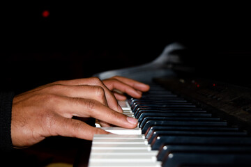 hands of a person playing the piano