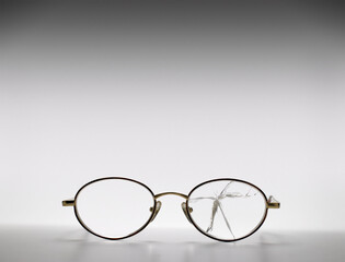 Glasses with a broken lens. Broken Eyeglasses on white background