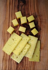  slicing cheese on a wooden board