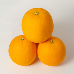 Some of the orange fruit on a white background. Square size of photo.