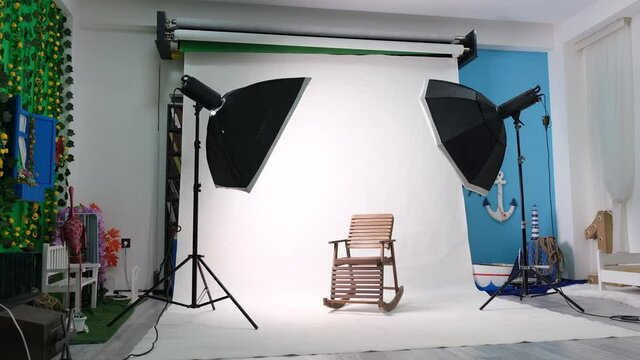 Photo or video studio with two hexagone studio lights. White screen and rocking chair
