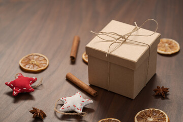 Christmas gift box from eco friendly paper wrapped with natural twine on wood table with natural decorations
