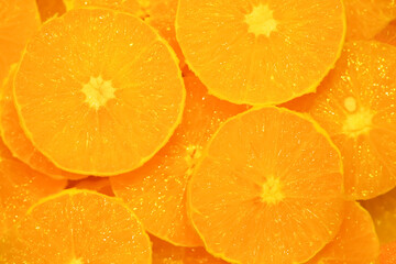 Citrus background. Sliced peeled oranges wedges