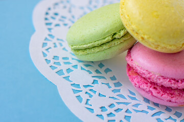 Infrared thermometer with digital green colored screen showing high body temperature on pile of medical masks and pills in blisters. on blue background. Concept of stopping virus illness and influenza