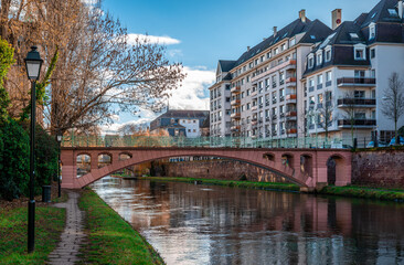 View of Passerelle du Faux Rempart, a brick wall bridge, spanning Canal du Faux-Rempart, in Strasbourg, Alsace, France.