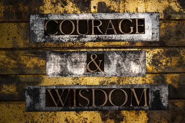 Courage & Wisdom text on vintage textured bronze grunge copper and gold background - obrazy, fototapety, plakaty