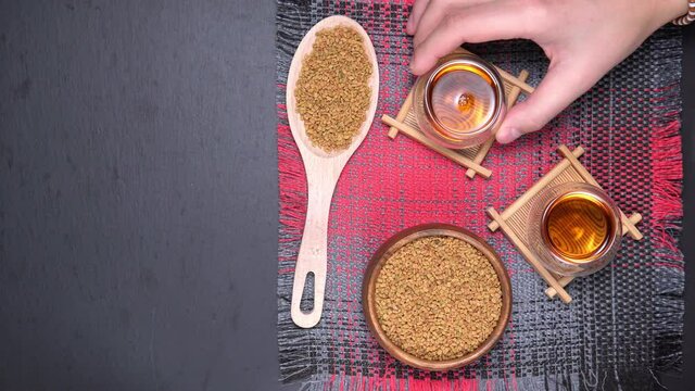 Fenugreek Seeds or MethiDana drink by speaking it in water overnight. close up. flat lay