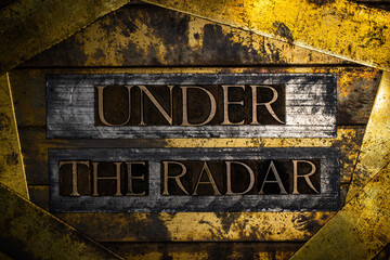 Under The Radar text on vintage textured bronze grunge copper and gold background