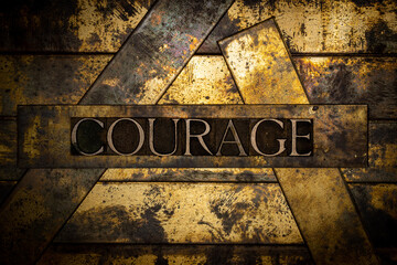 Courage text on vintage textured bronze grunge copper and gold background