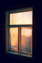 Old frozen window and mystical light.