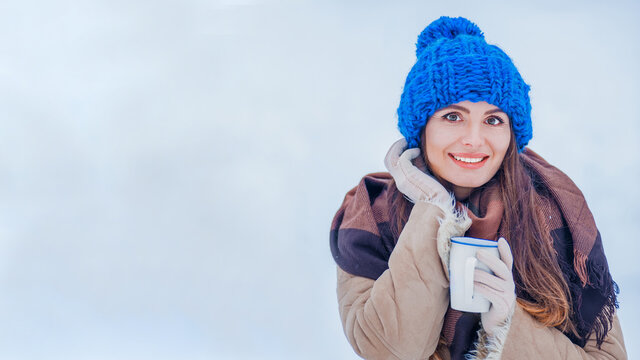 Woman In Winter Hat And A Cup In Hand