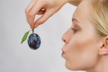 Girl holds plum fruit