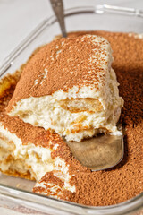 Italian dessert tiramisu on a glass container
