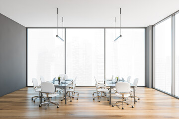 Grey office room with white chairs near window on parquet wooden floor