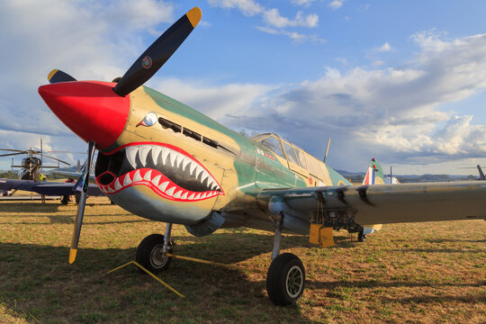 A World War II era Curtiss P-40E Kittyhawk fighter plane with a shark's mouth painted on the nose