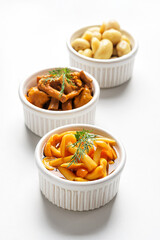Fermented food. Canned mushrooms in bowls on a white background.