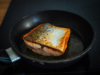 Frying salmon steak in pan
