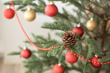 Part of red and gold decorated Christmas tree on the light bokeh backgrount