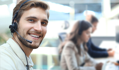Smiling positive young businesspeople and colleagues in a call center office.