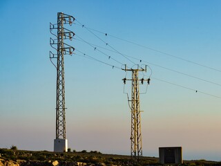 High voltage towers at sunset