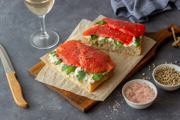 Open sandwiches with salmon, arugula and white cheese. Healthy eating.