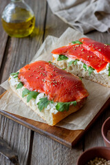 Open sandwiches with salmon, arugula and white cheese. Healthy eating.