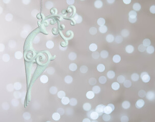 White deer. Bokeh. New Year's magic. Christmas tree toy
