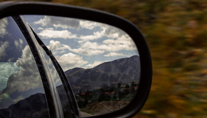 Looking at the road in the rearview mirror.