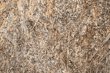 OSB board texture. Brown wooden background. Simple pressed chipboard pattern. Chip board background.	Grunge construction site texture.