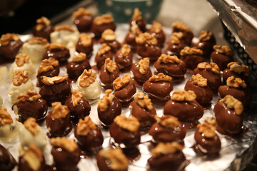 Close up of tray in german kitchen with group fresh homemade shiny fig walnut marzipan pralines
