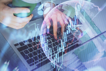 Double exposure of woman hands typing on computer and forex chart hologram drawing. Stock market invest concept.