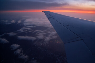 Fototapeta na wymiar Aircraft wing from passenger cabin at evening