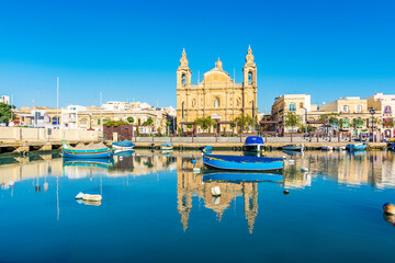 The Msida (Imsida) harbor view with beautiful mirror reflection of boats and Parish Churc  in west of Valletta, Malta.