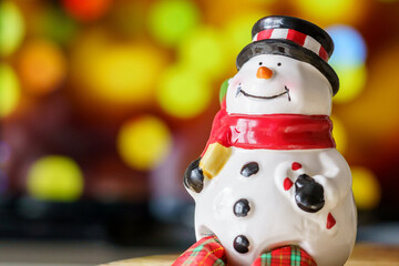 Snowman, Christmas Ornament with colored bokeh background and copy space