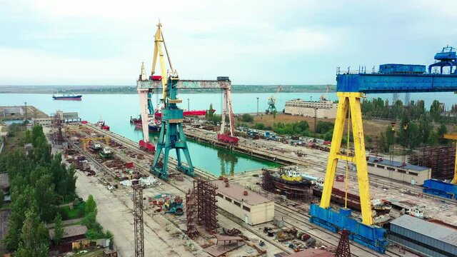 Top view on the shipyard port, ship building facility. View from above on the dockyard near the river in the city.