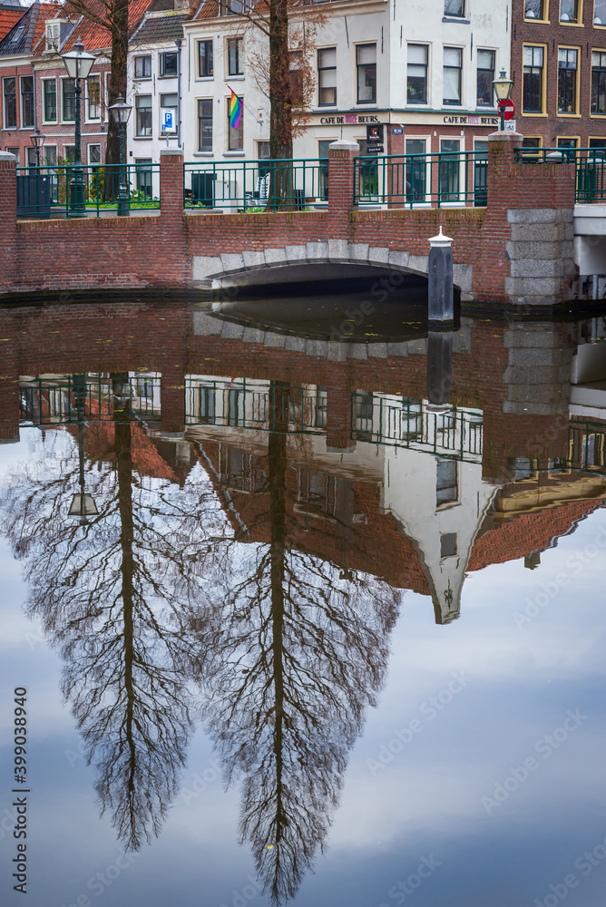 Wall mural 2 december, 2020 leiden netherlands, reflection of high trees in the water of canal