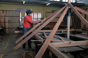 Installation of roof rafters on a new gazebo construction project in the workshop