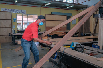 Fototapeta premium The carpenter using measuring tape in setting out process for installing roof rafters on a new gazebo construction project