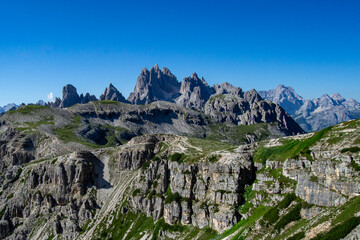 Dolomites alpine mountains landscape with blue sky and spot clouds