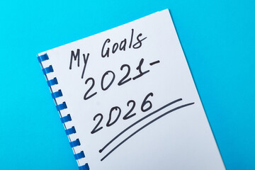 My goals for 2021-2026. Long-term planning for five years. The inscription on a notebook on a blue background.